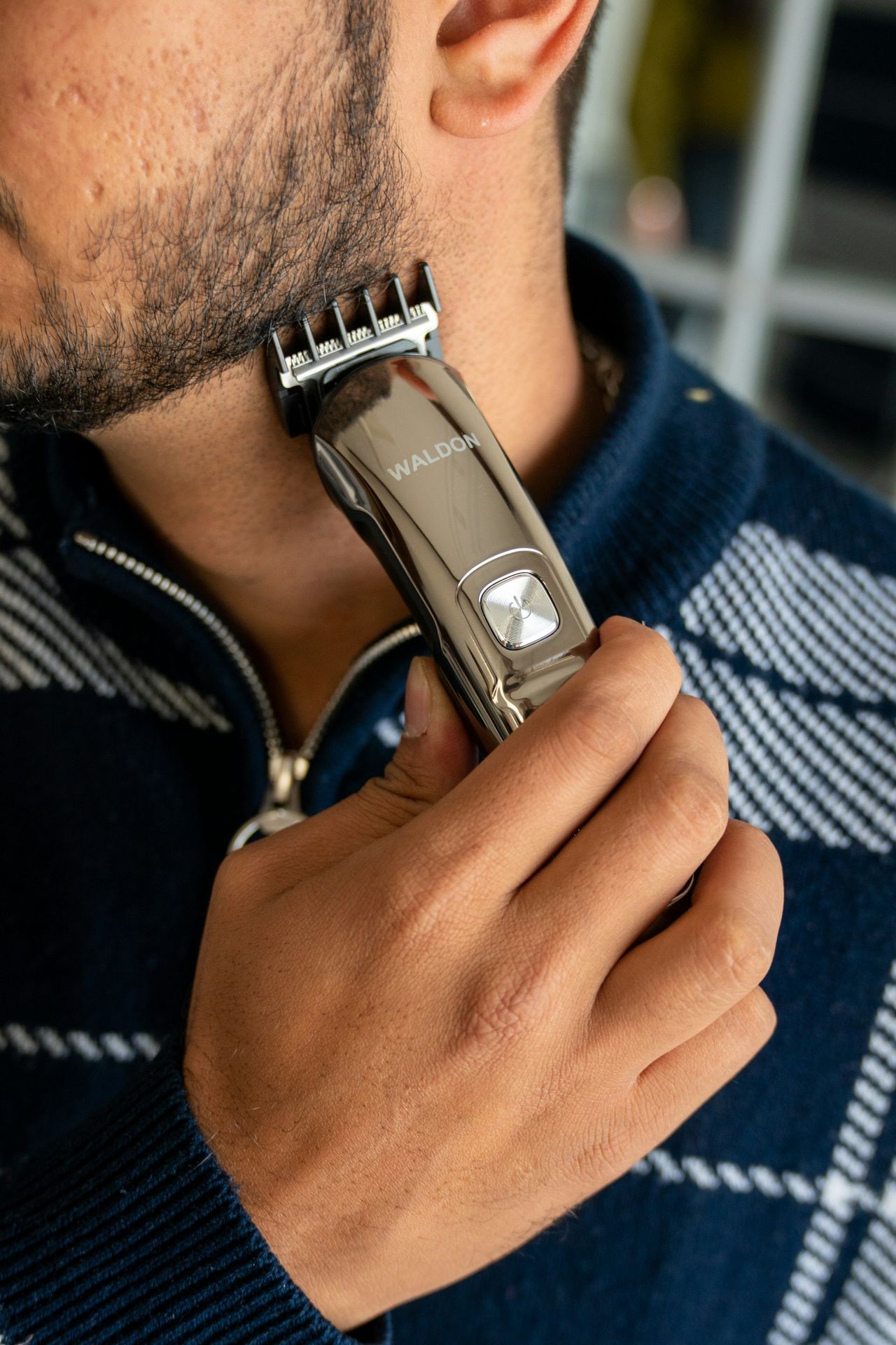 a man holding a hair clip in his hand